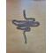 Stainless steel chain necklace on a table. Chain links are medium size. Necklace laid in a vertical heartbeat symbol. 